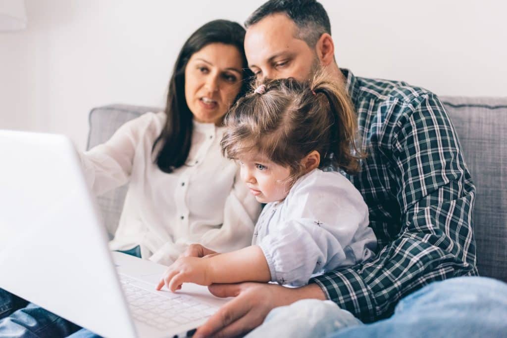 Happy family indoor apartment using computer